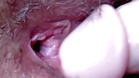 Beautiful brunette with hairy pussy riding a dildo