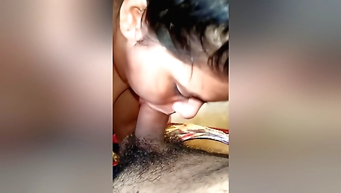 Brunette in black dress sucks a dick in a hotel room