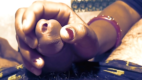 A brunette teen is getting a handjob on the studio desk