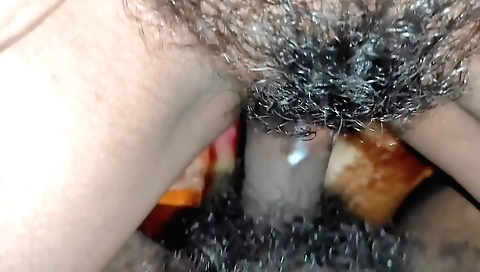 Horny hairy babe gets on the bed and takes off stockings