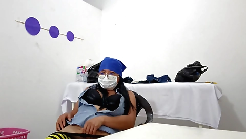 A brunette nurse in red stockings shows off her ass